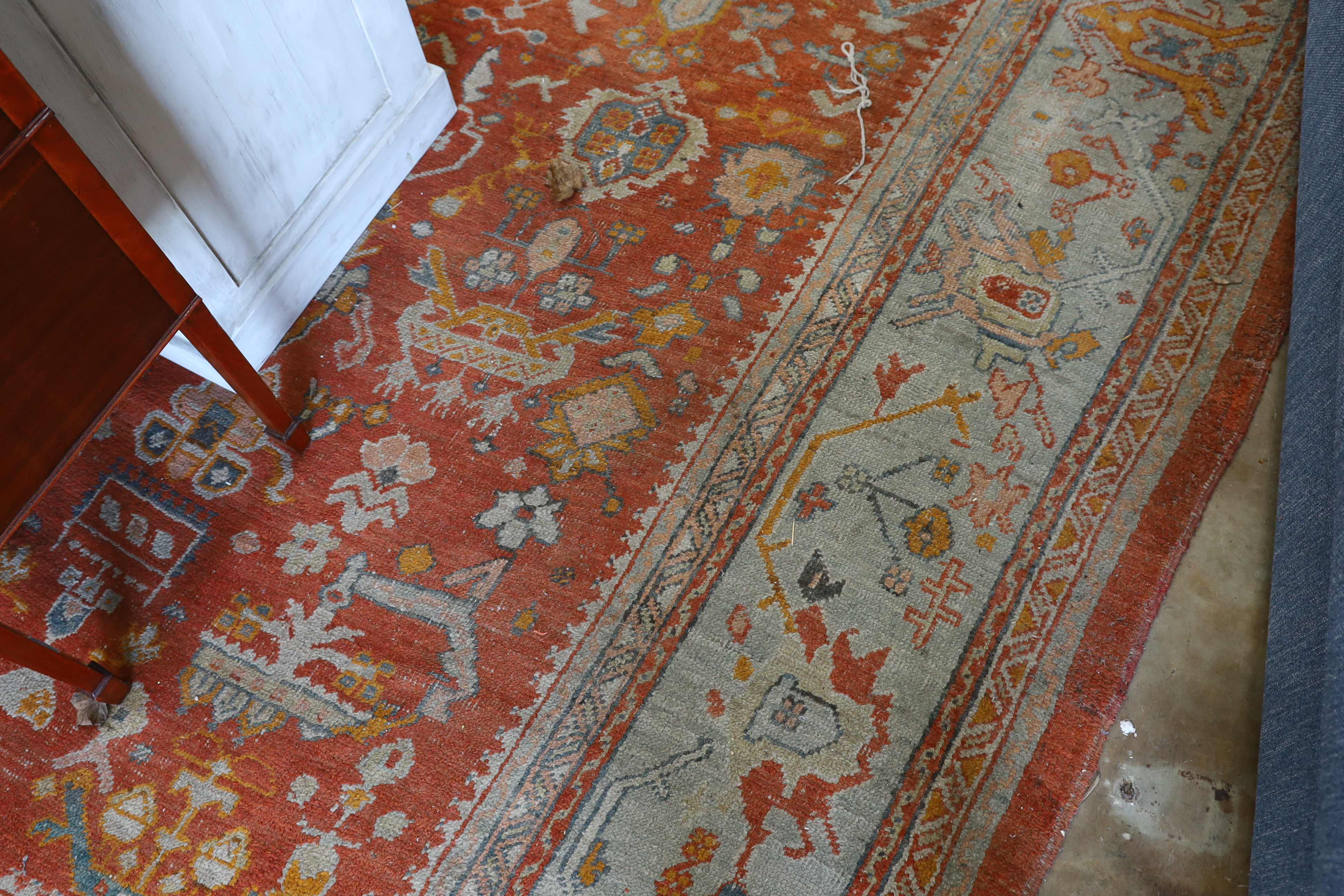 An Afghan red ground carpet, 395 x 310cm